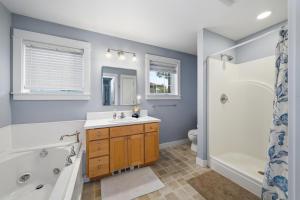 a bathroom with a sink and a tub and a toilet at Becalmed MCA#1653 in Manzanita +34 photos
