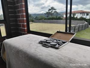 a laptop sitting on top of a table next to a window at Casa Campestre Familiar in Medellín