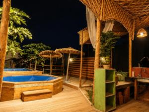 a resort with a hot tub and a table and umbrellas at Appartement Riad à Taroudant Piscine Privée & Grand Jardin, Séjour Unique in Taroudant