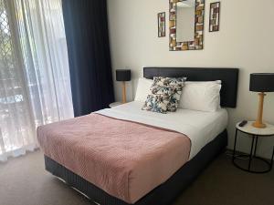 a bedroom with a bed and a mirror on the wall at Serenity in Surfers Paradise in Gold Coast