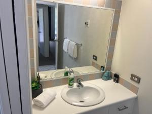 a bathroom with a sink and a mirror at Serenity in Surfers Paradise in Gold Coast +11 photos