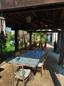 a table and chairs on a patio with a table and a table and chairs at Casa Vicino in Carrù