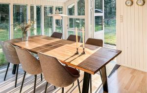 a wooden table in a room with chairs around it at Stunning Home In Højslev With Wifi in Højslev