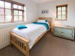 a small bedroom with a bed and a night stand at 3 Bed in York oc-hh015 in Tockwith