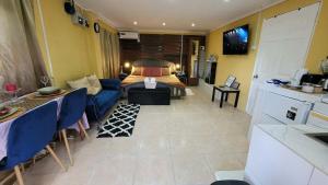 a living room with a couch and a bed at Comfort Suites - Studio Two in La Fargue