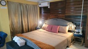 a bedroom with a bed with two pink pillows at Comfort Suites - Studio Two in La Fargue +23 photos