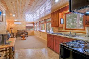 a kitchen with wooden cabinets and a stove top oven at Riverside Motel in Hayward