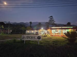 a sign in front of a house at night at Mulu D Cave Homestay Room 2 in Mulu