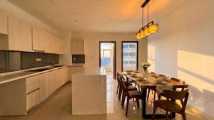 a kitchen with a long dining table and chairs at Suasana JB Central by TPL in Johor Bahru