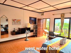 a room with a bed and a desk and a room with a desk at west water hotel in Vang Vieng