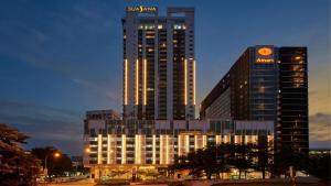 a tall building with a sign on top of it at Suasana JB Central by TPL in Johor Bahru