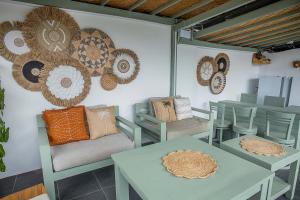 a room with tables and chairs and plates on the wall at D'Yuki Huts Lembongan in Nusa Lembongan