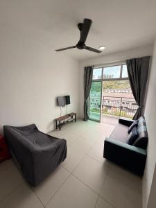 a living room with a couch and a ceiling fan at Peace Homestay 2 in Brinchang