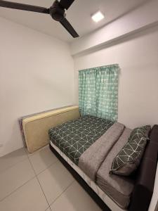 a bedroom with a bed and a ceiling fan at Peace Homestay 2 in Brinchang