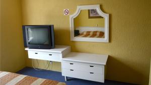 a bedroom with a tv on a dresser with a mirror at Hotel San Jeronimo Inn in Toluca +9 photos
