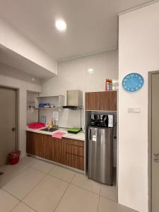 a kitchen with a stainless steel refrigerator and cabinets at Peace Homestay 2 in Brinchang