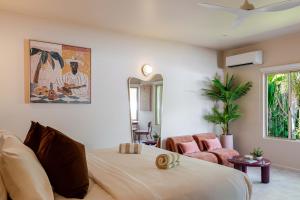 a bedroom with a bed and a mirror at CASA AMELIA - Boutique Studio in Port Douglas +14 photos