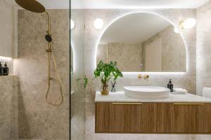 a bathroom with a sink and a mirror at CASA AMELIA - Boutique Studio in Port Douglas