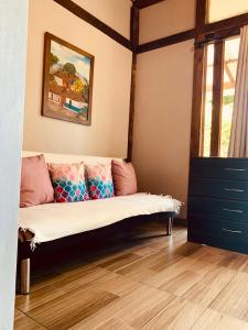 a living room with a couch in the corner at Quirama Lodge Oriente Antioqueño in Carmen de Viboral
