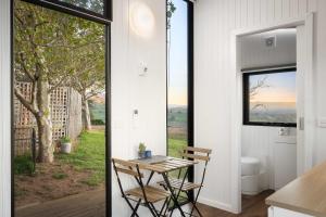 a room with a table and chairs and a window at Nichol Road Hideaway at Annies Retreat by Tiny Away in Yackandandah +14 photos