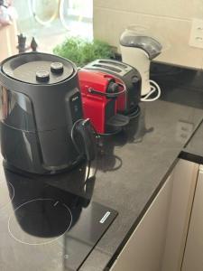 a counter with two coffeemakers sitting on a counter top at Studio 404 Premium Flat - Juazeiro do Norte - Cariri in Juazeiro do Norte +2 photos