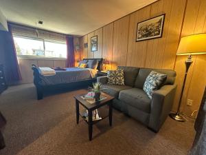 a living room with a couch and a bed at Guesthouse Austria in Stewart