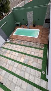 a swimming pool in a backyard with a wooden deck at Chácara Santa Fé in Iguatu