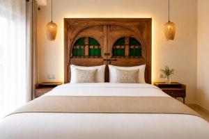 a bedroom with a large white bed with two pillows at Luxury Apartment with Private Jacuzzi & Pool Central Marrakech in Marrakesh +30 photos