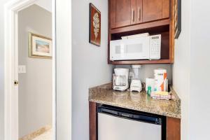 a kitchen with a counter top with a microwave at Resort Studio with Nature Preserve Views in Destin