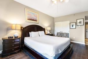 a bedroom with a large bed and two lamps at Resort Studio with Nature Preserve Views in Destin