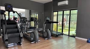 a gym with several treadmills and elliptical machines at Tropical Executive Hotel in Manaus