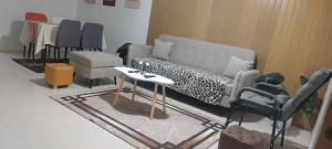 a living room with a couch and a table and chairs at Mike's Staycation in Clark in Angeles