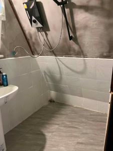 a bathroom with a shower head and a sink at Hidden Gem Elephant in Chiang Mai