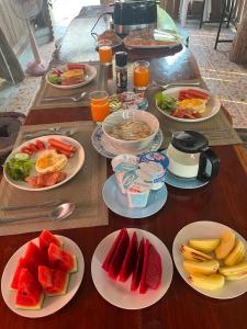 a table with plates of food and fruit on it at Hidden Gem Elephant in Chiang Mai