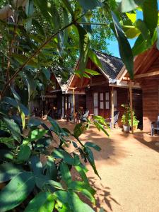 a house with a tree in front of it at Cool Banyan Cabana in Trincomalee