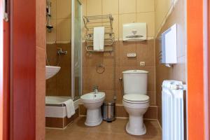 a bathroom with a toilet and a sink at Elit Garden Hotel in Kamianets-Podilskyi