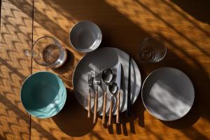 a table with plates and cups and utensils at good day biei in Biei