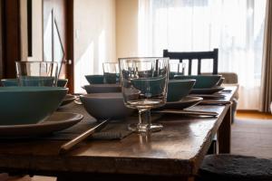 a long wooden table with bowls and glasses on it at good day biei in Biei