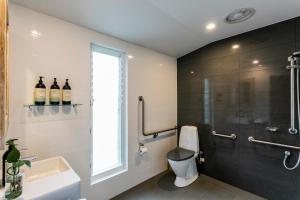 a bathroom with a toilet and a glass shower at Stablebase in Albany +12 photos