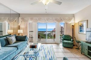 a living room with a couch and a view of the ocean at TOPS'L Summit 1013 in Destin