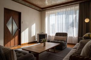 a living room with a couch and a coffee table at good day biei in Biei