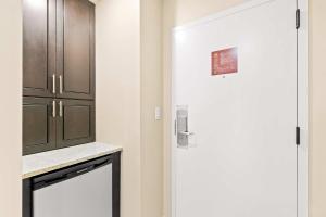a kitchen with a white door and a cabinet at TOPS'L Summit 207A in Destin