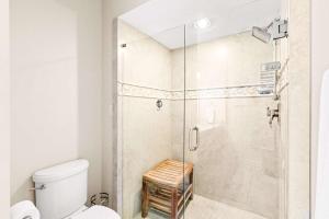 a bathroom with a shower with a glass door at TOPS'L Summit 207A in Destin