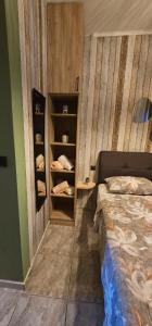 a bedroom with a bed and a shelf with shoes at Alora Cosy Suite in Kefalos