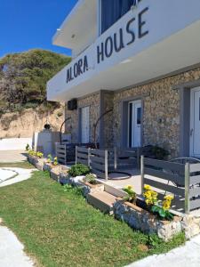 a naia house with benches in front of it at Alora Cosy Suite in Kefalos