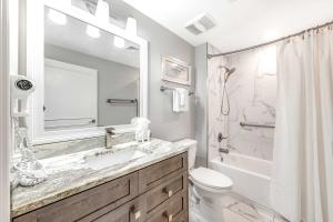a bathroom with a sink and a shower and a toilet at Condo with Shoreline Views and Resort Pools in Destin