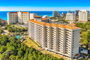 an aerial view of a large building in a city at TOPS'L Summit VI in Destin