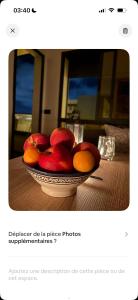 a bowl of apples and oranges on a table at Chambre avec WC privée pr 1p dans un appart partagé avec 1p in Sidi Maarouf