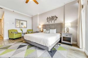 a bedroom with a large bed and a yellow chair at TOPS'L Summit 1108A in Destin