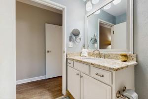 a bathroom with a sink and a mirror at TOPS'L Summit 107b in Destin +20 photos